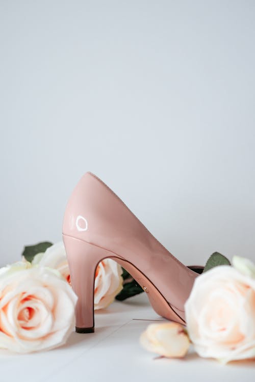 A pair of pink high heels with roses