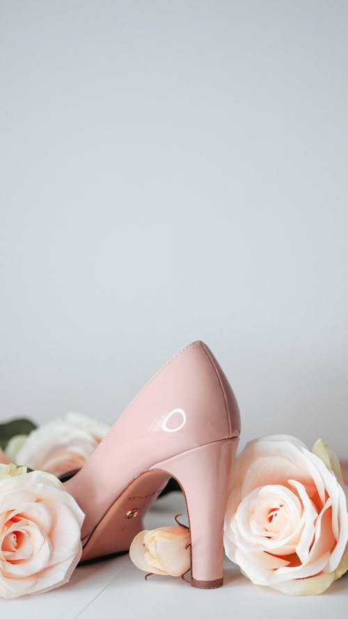 A pair of pink high heels and roses