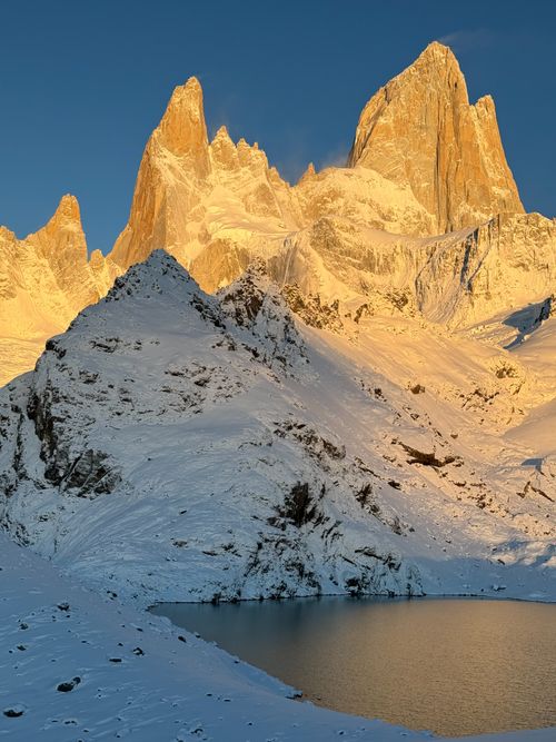 Free Golden sunrise over Fitz Roy, Argentina with snow and pond reflection. Stock Photo