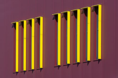 Free Contemporary building facade featuring bold yellow accents in urban setting. Stock Photo