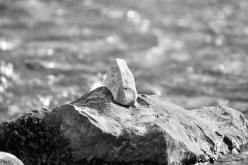 Free Artistic black and white photo of rocks balancing on a riverbank. Stock Photo