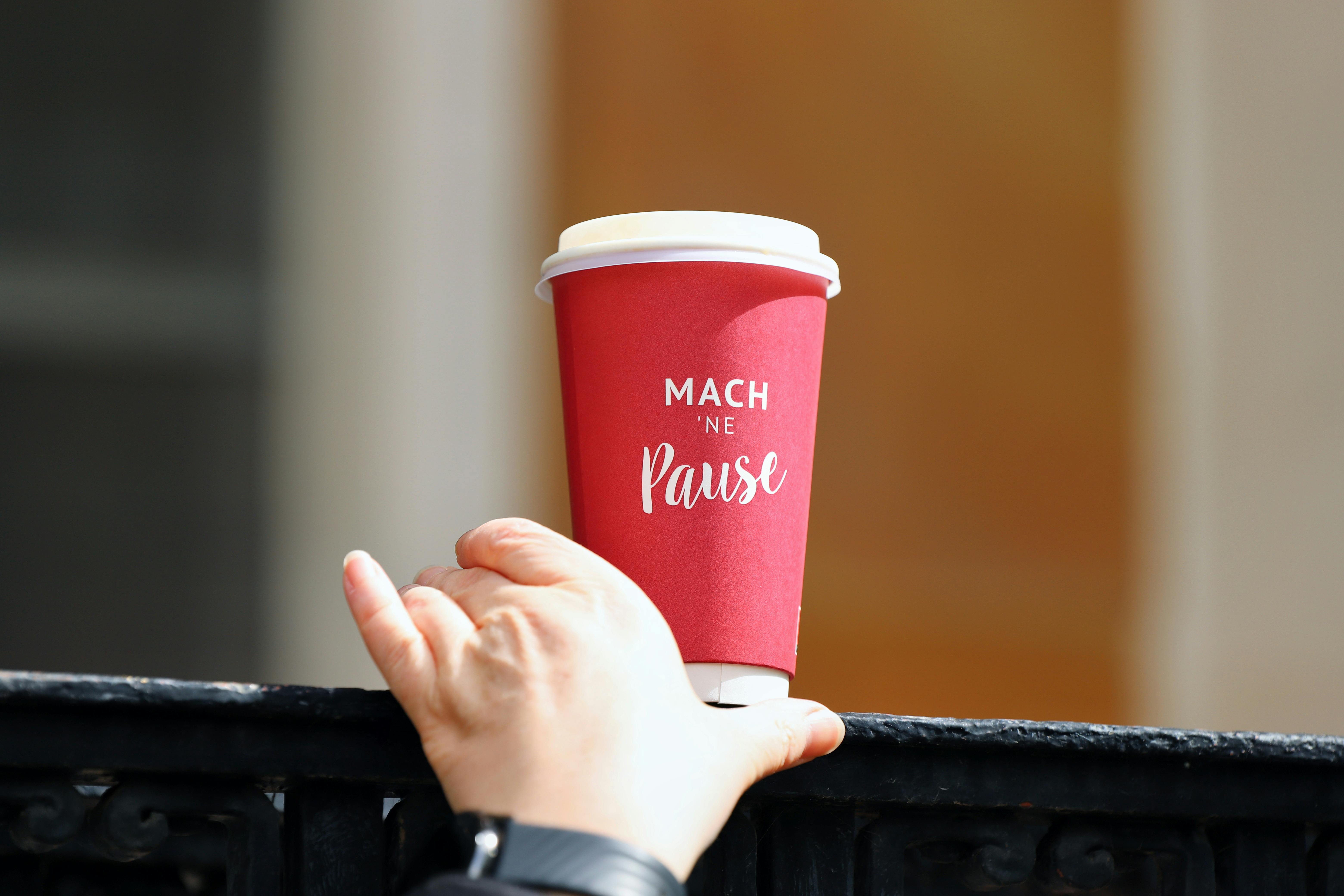Hand Grabbing Red Paper Cup · Free Stock Photo