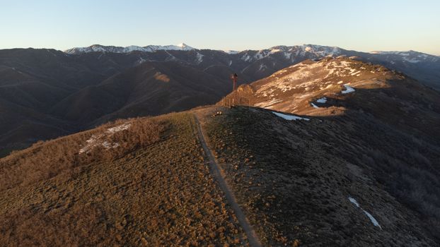 Breathtaking aerial view of a rugged mountain range near Salt Lake City during sunset.