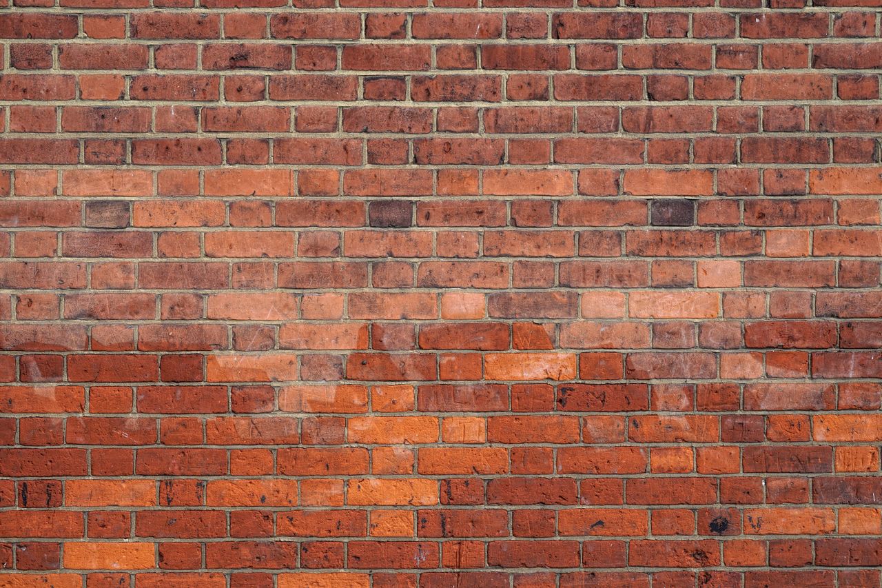 detailed image of a red brick wall ideal for use as a background textu