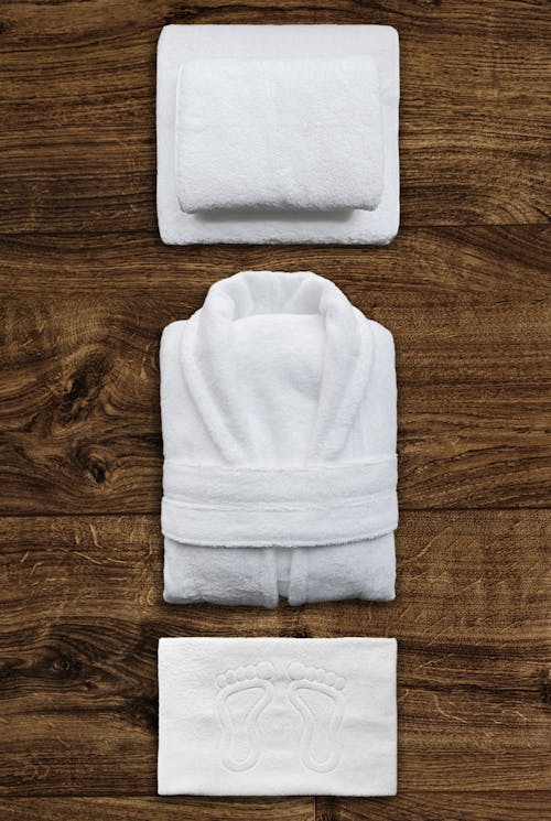 A set of towels and a towel on a wooden surface