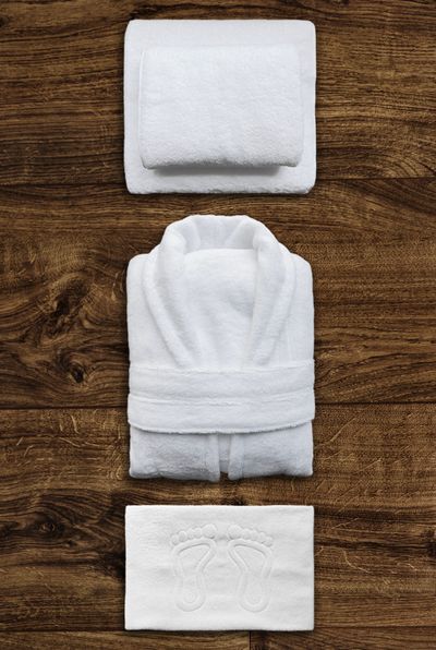 Folded cotton waffle robe on wood — photo by Dmitriy Steinke on Pexels