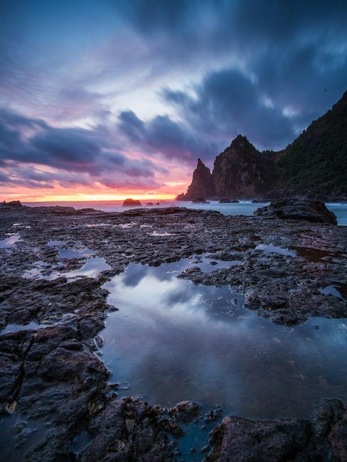 Majestic ocean sunset with stunning reflections on rocky seashore. Perfect nature seascape.