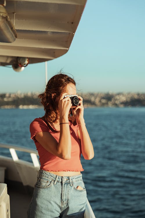 Brunette Woman with Camera on a Boat