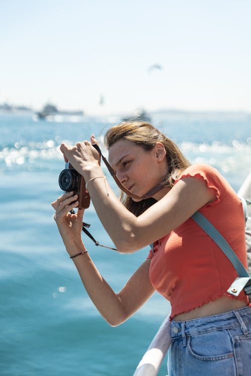 A woman taking a photo on a boat