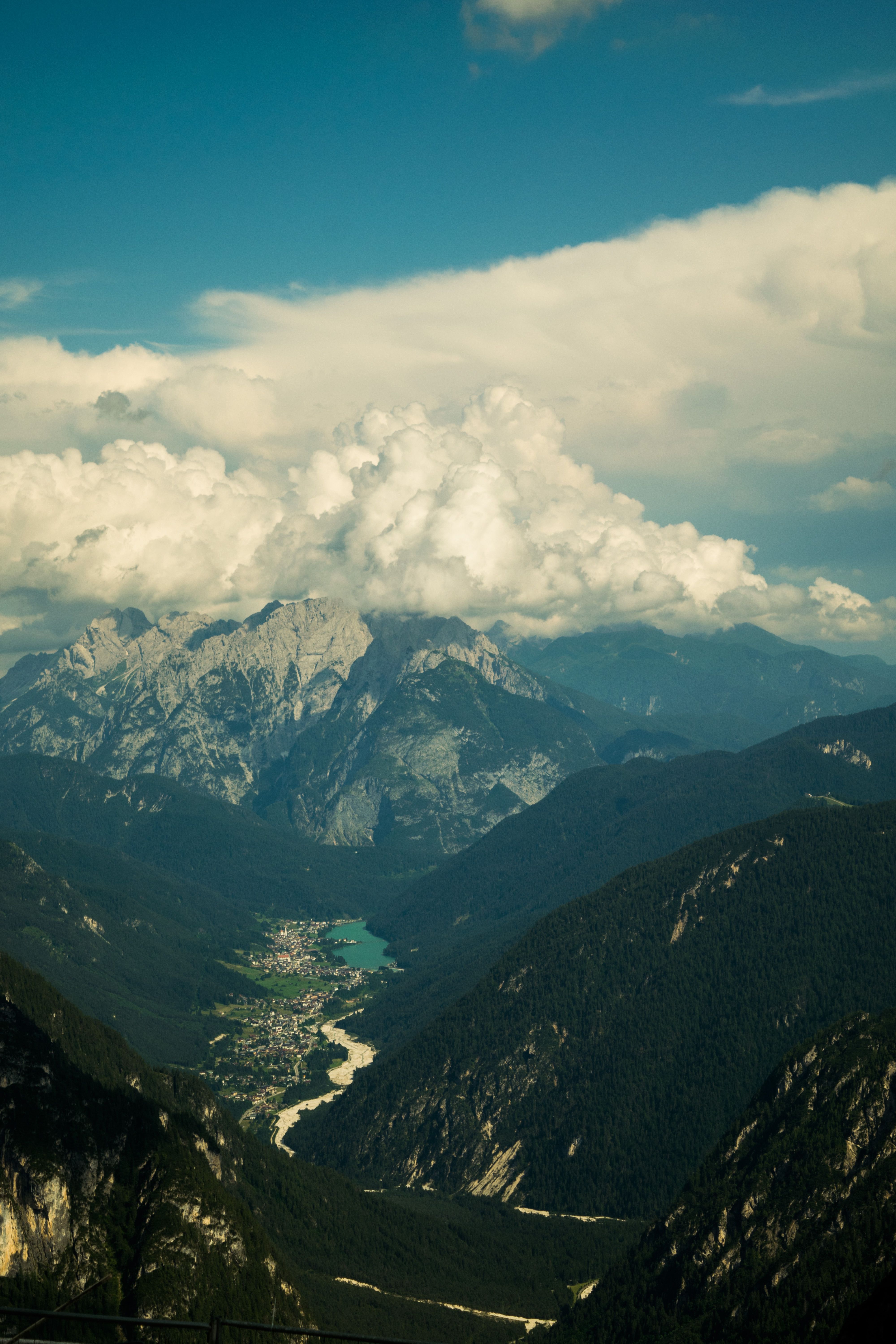 Valley surrounded by mountains under a cloudy sky — photo by Schubërt Schneider on Pexels