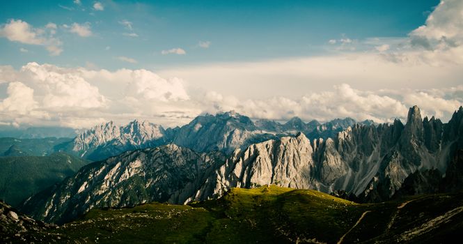 Breathtaking view of rugged mountains with dynamic cloud formations, capturing nature's majesty.