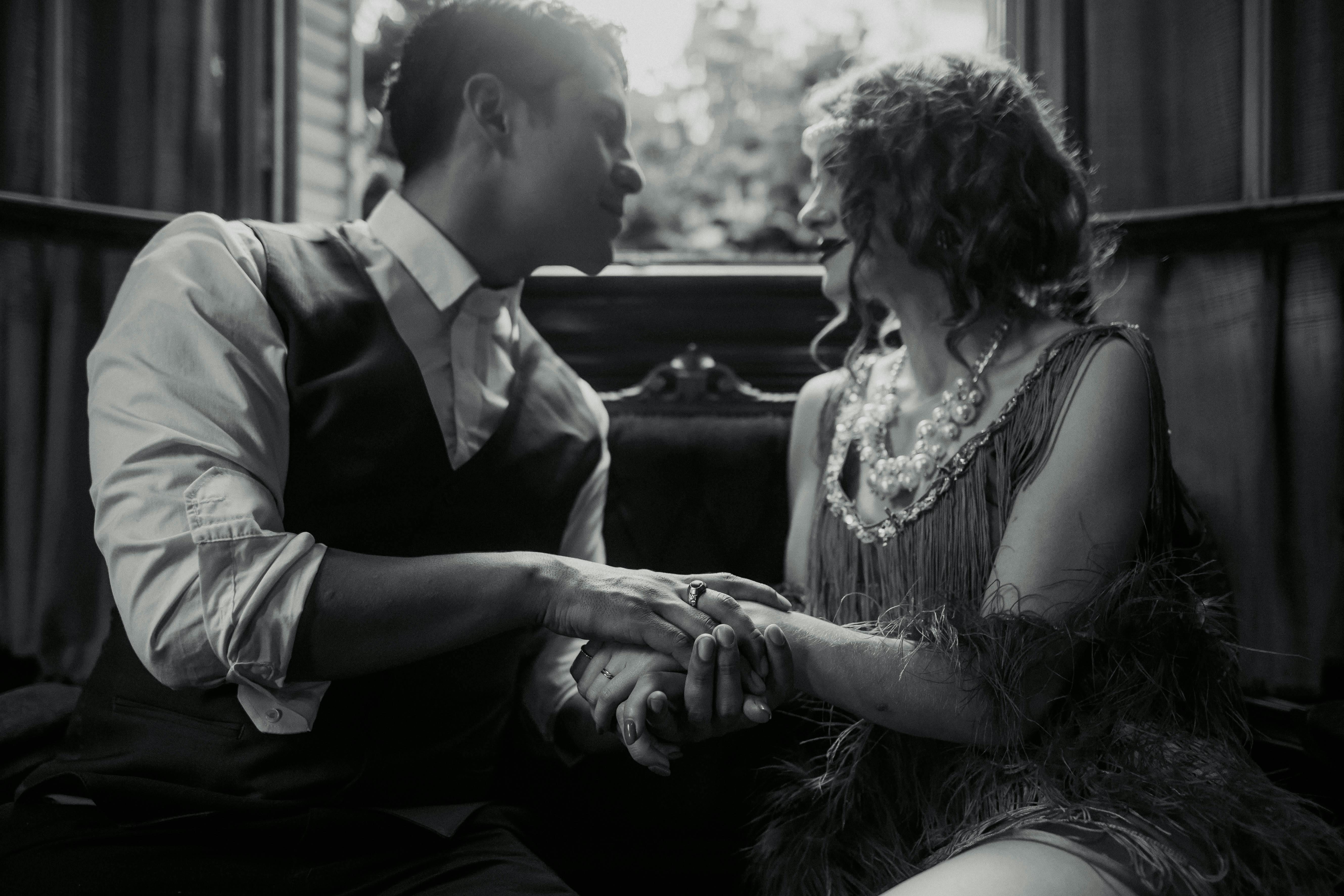 couple in retro clothing sitting together and holding hands