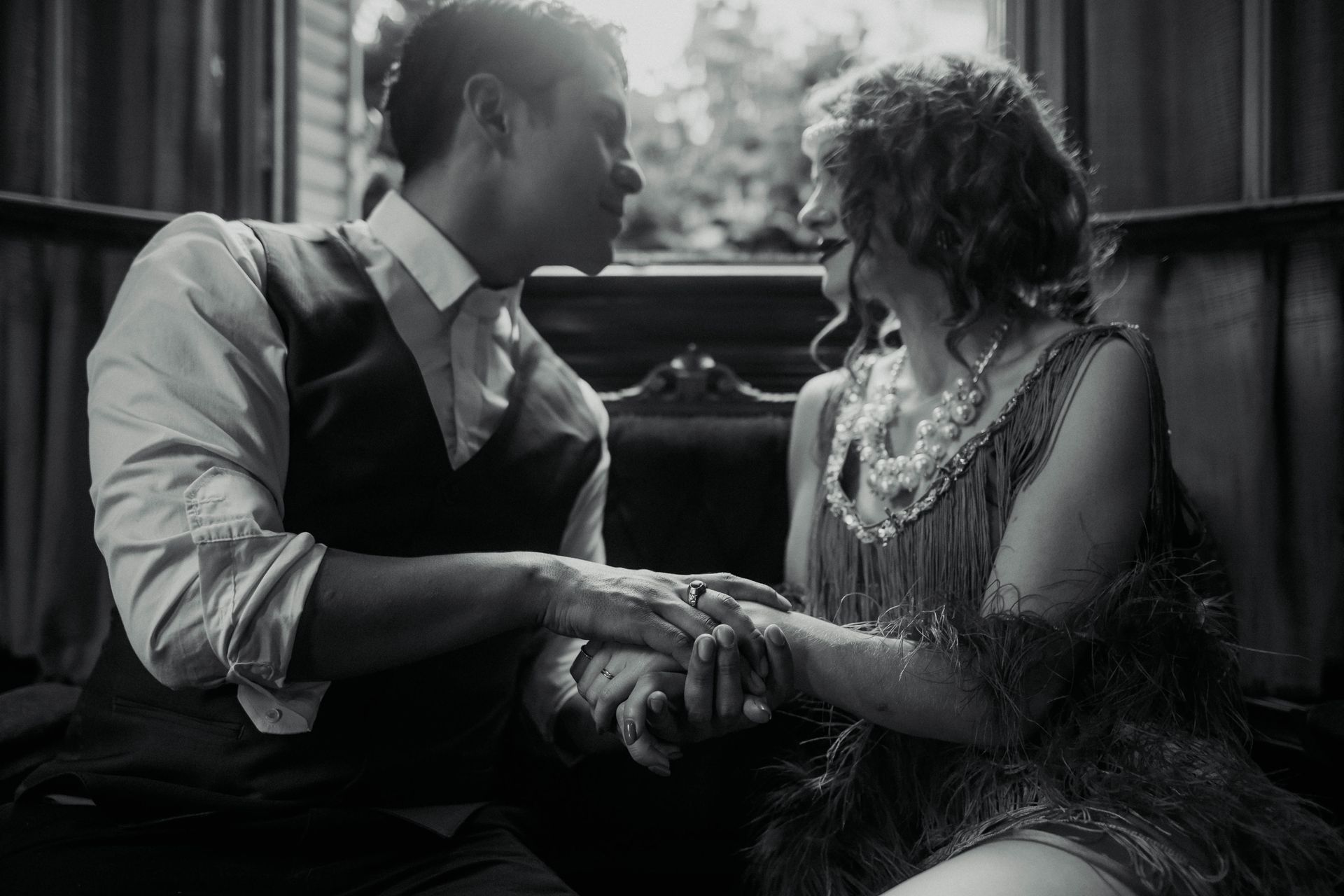 Couple in Retro Clothing Sitting Together and Holding Hands