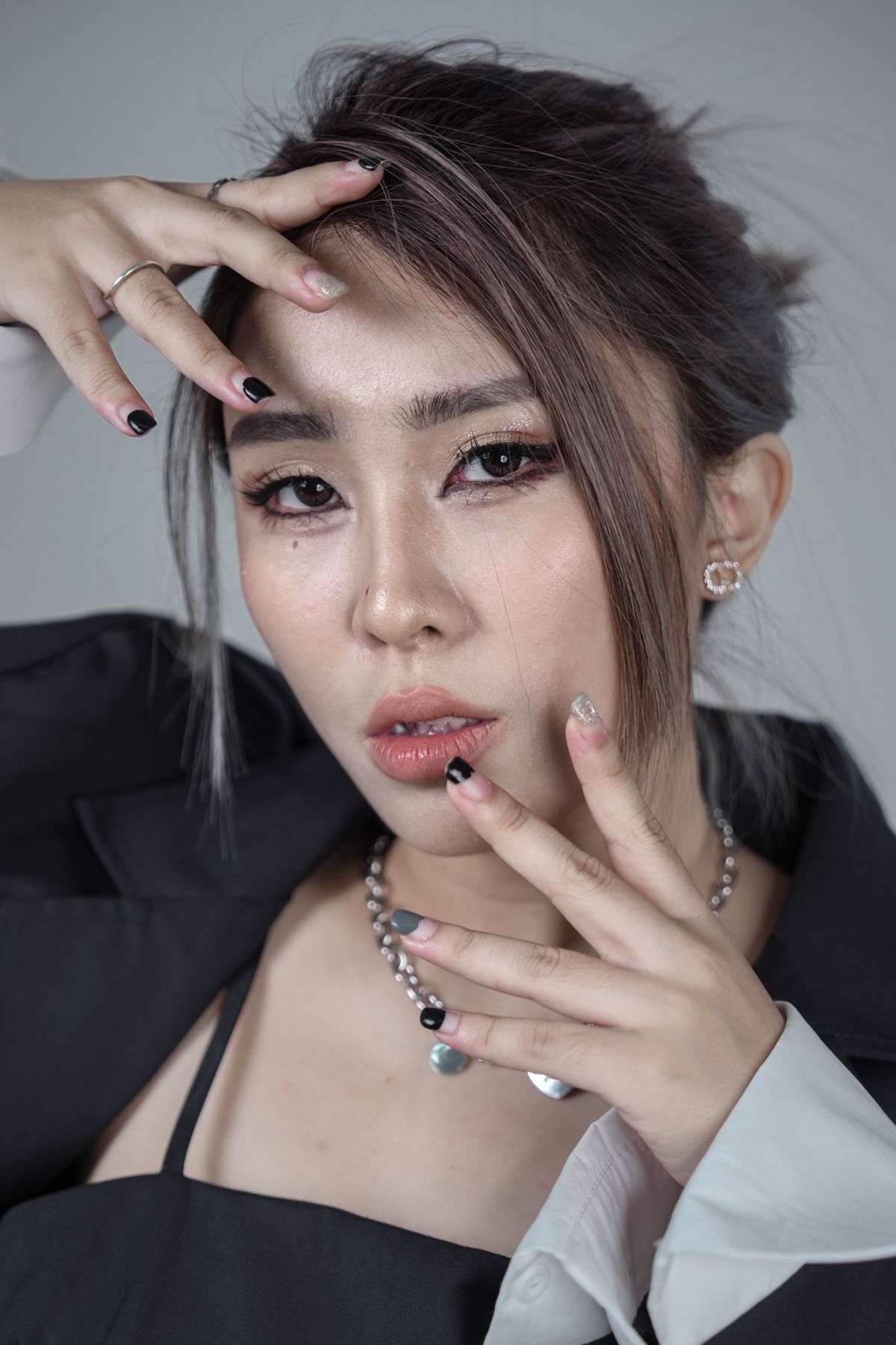Editorial portrait of an elegant woman, hand near her face