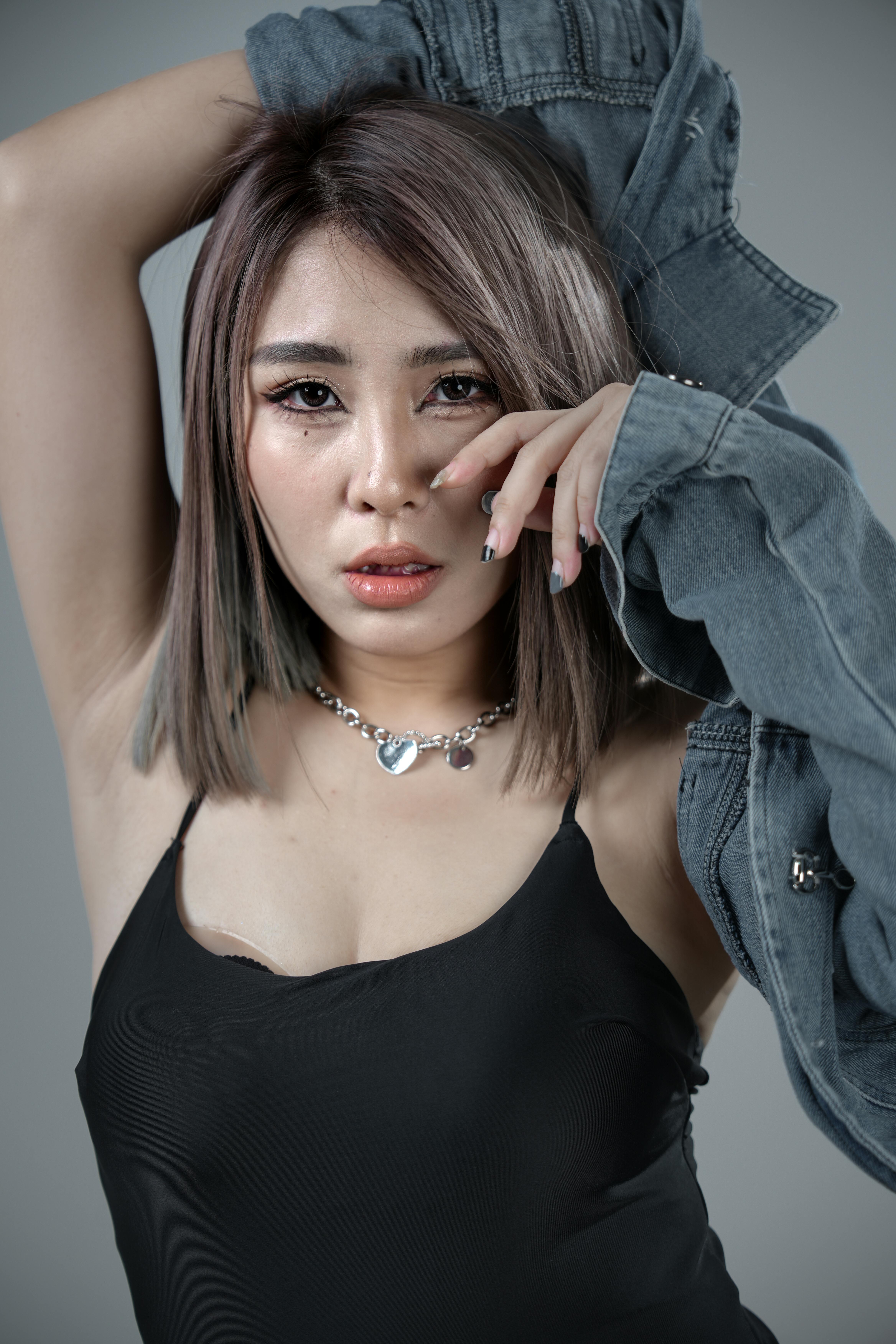 Bold portrait of a woman in denim showcasing modern fashion with a stylish pose.