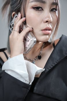 Fashionable young woman talking on smartphone, showcasing modern communication and style.