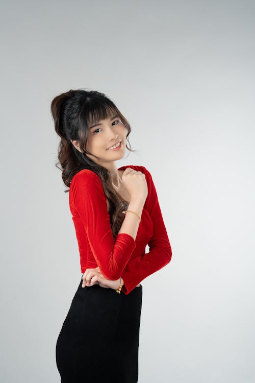 A woman in a red shirt posing for a photo