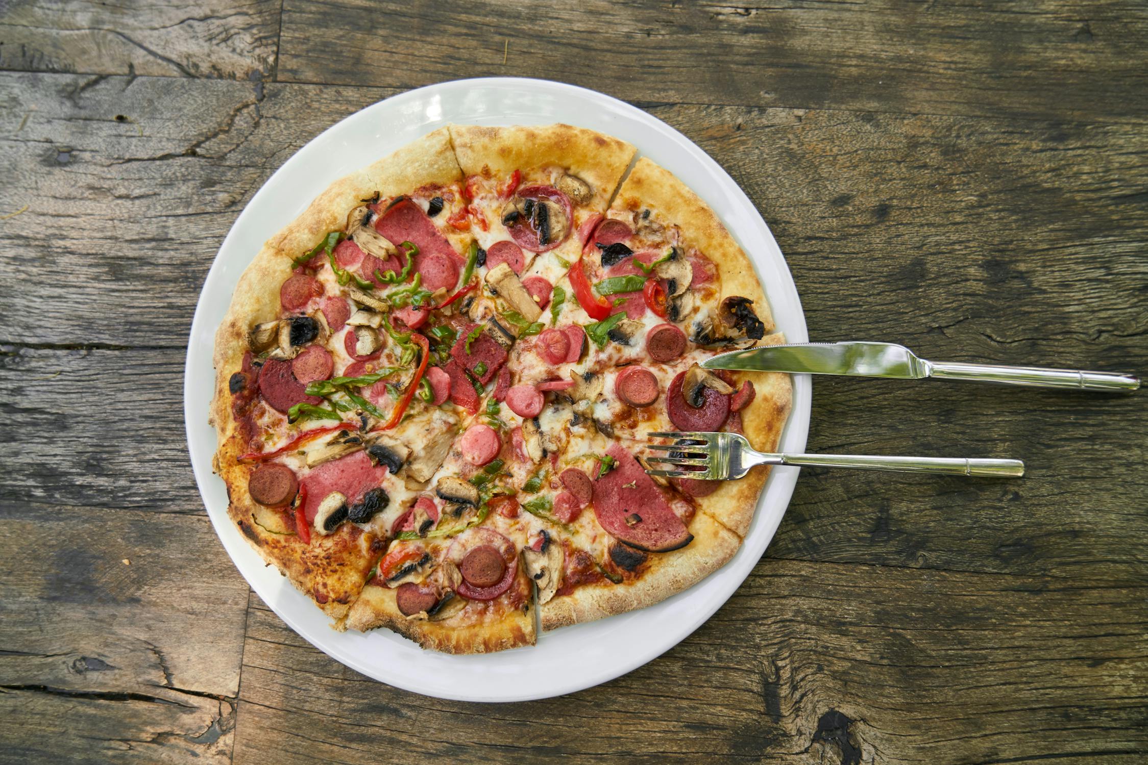 Pizza on Plate With Slicer and Fork · Free Stock Photo