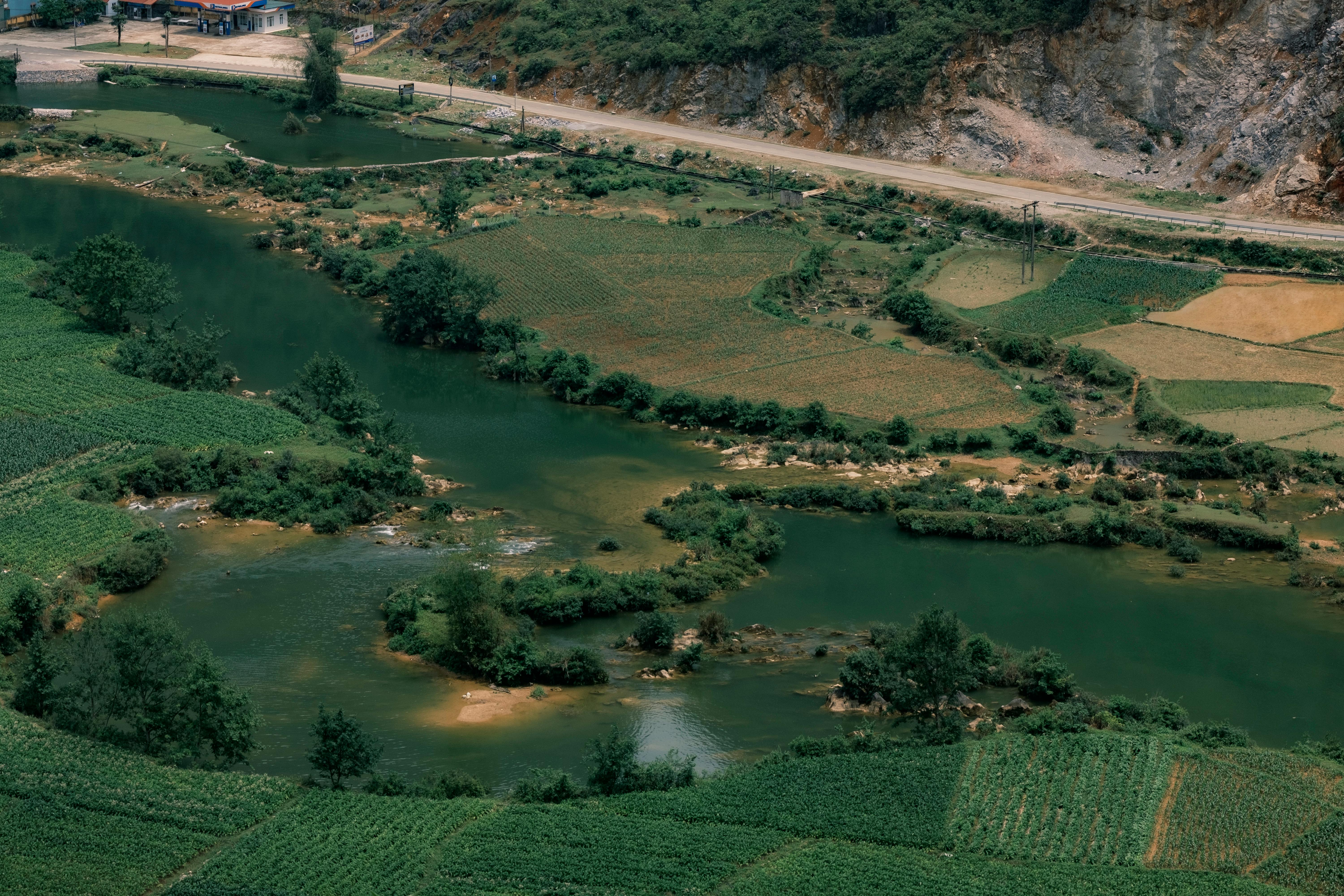 Explore the lush fields and winding river captured in an aerial view of Cao Bằng, Vietnam.