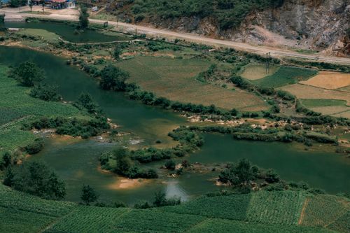 Free Explore the lush fields and winding river captured in an aerial view of Cao Bằng, Vietnam. Stock Photo