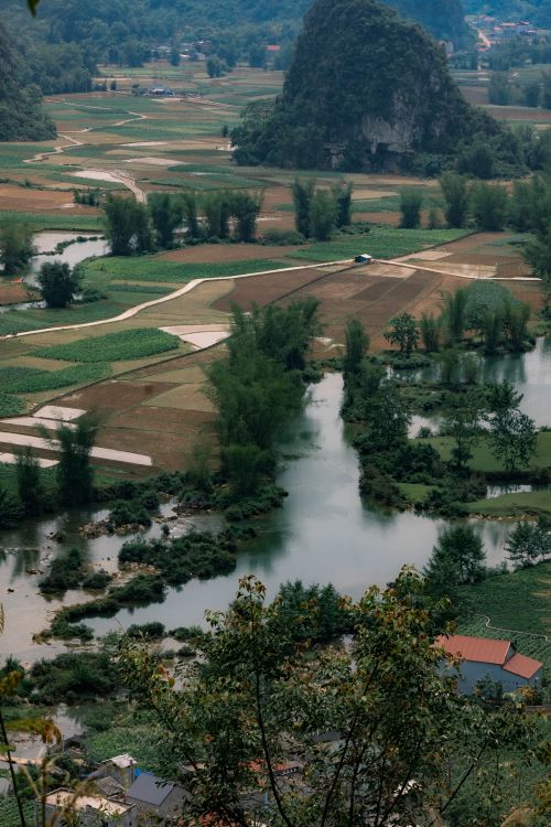 Free A captivating aerial view of a lush rural landscape in Cao Bằng, Vietnam featuring fields, rivers, and hills. Stock Photo