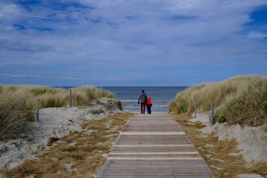 family on beach boardwalk