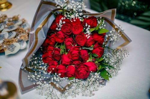 A bouquet of red roses is sitting on a table