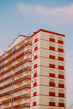 Vibrant apartment building with red balconies in Mar del Tuyú, Argentina.
