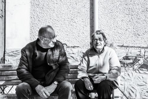 Free Black and white portrait of an elderly couple sitting on a bench in Parcoul-Chenaud, France. Stock Photo