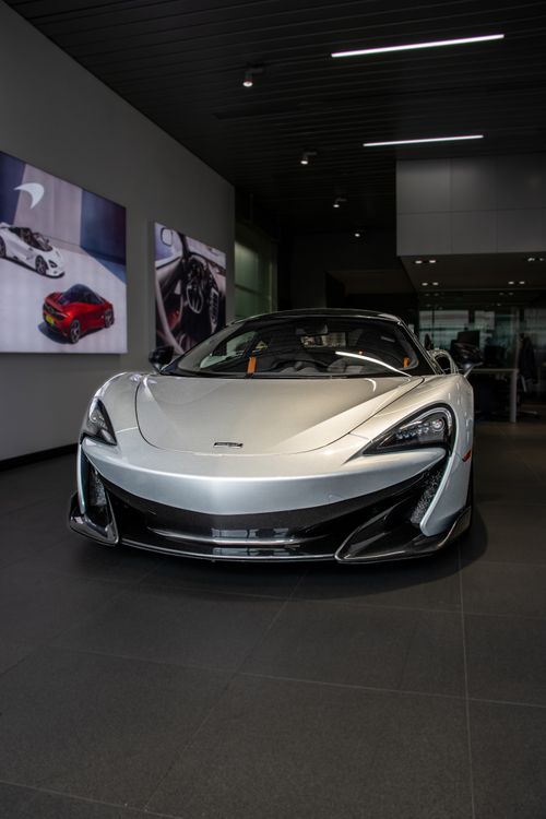 Free Silver supercar displayed indoors with modern design and elegance. Stock Photo