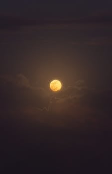 A mesmerizing full moon illuminating the cloudy night sky in Akumal, quintana roo.