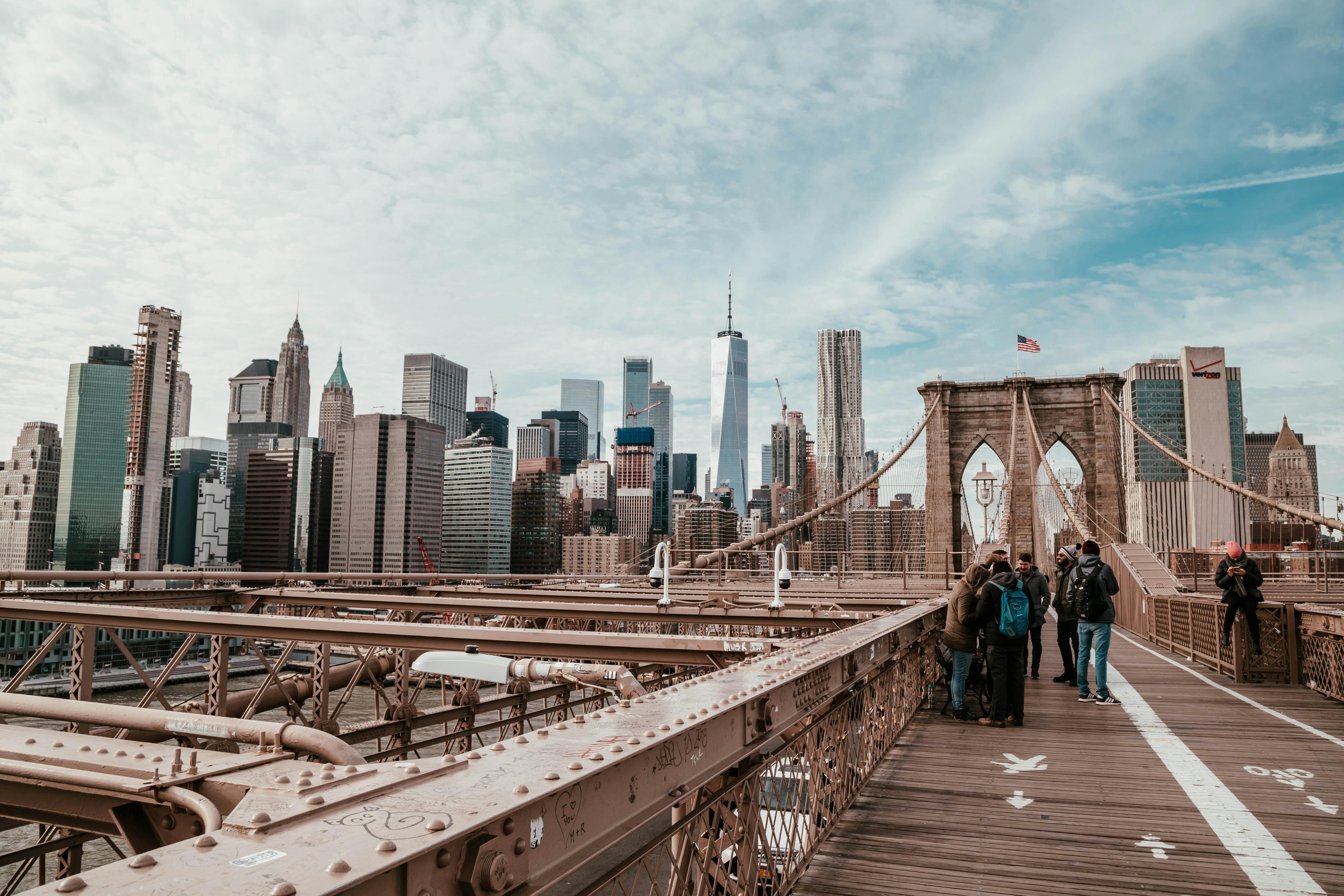 people standing on brown bridge