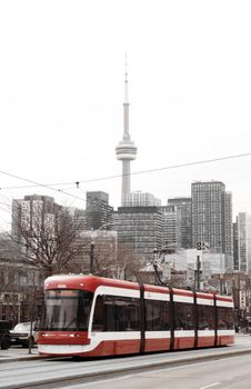 Toronto's streetcar with CN Tower in the backdrop showcasing urban city life.