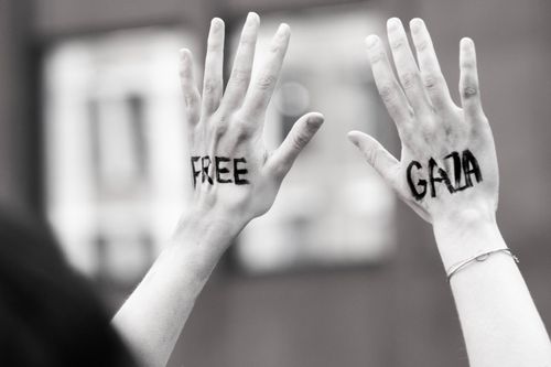Free Hands raised with 'Free Gaza' message during a protest, symbolic and expressive. Stock Photo