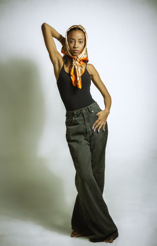 A woman in a black top and wide pants