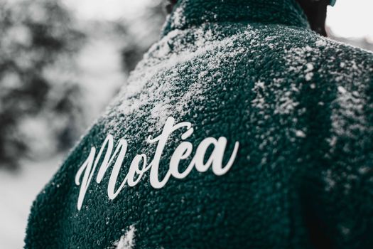 Close-up of a teal jacket with snow and Motéa branding in Brezovica, Serbia.