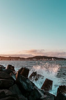 日出时分，海浪撞击岩石的壮丽景色，展现了大自然的力量与美丽