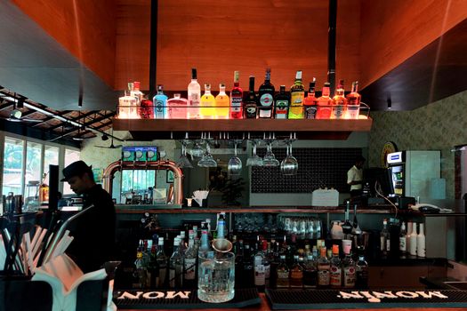 Elegant bar setup in Mahé India, showcasing vibrant liquor bottles and modern design.
