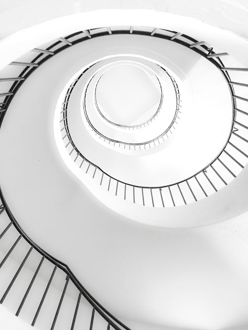 White Spiral Stairs With Black Metal Railings