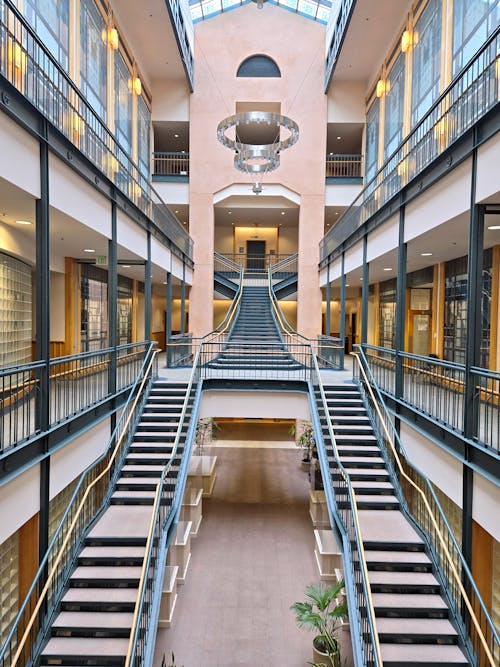 Ascending the staircase, the mesmerizing symmetry of its steps creates a captivating visual harmony within the building's architecture.