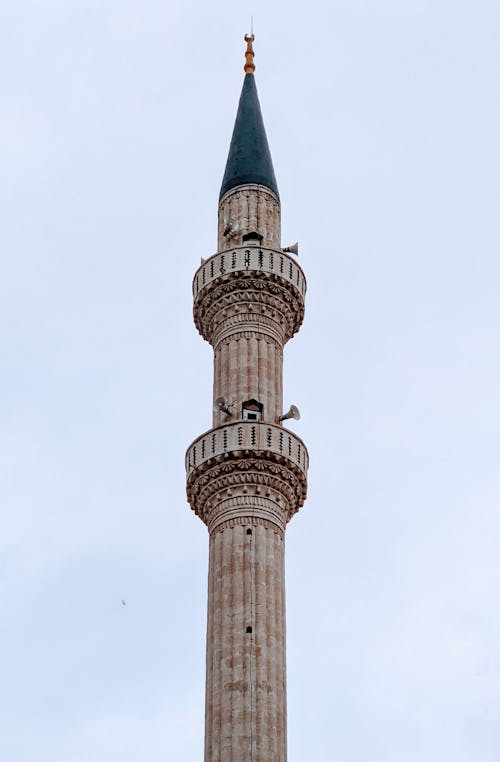 A tall tower with a green clock on top