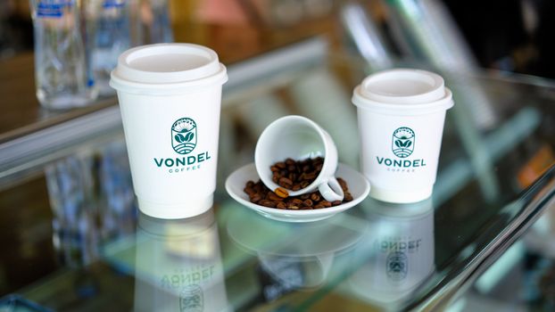 White paper coffee cups and coffee beans at Vondel cafe in Gaziantep.