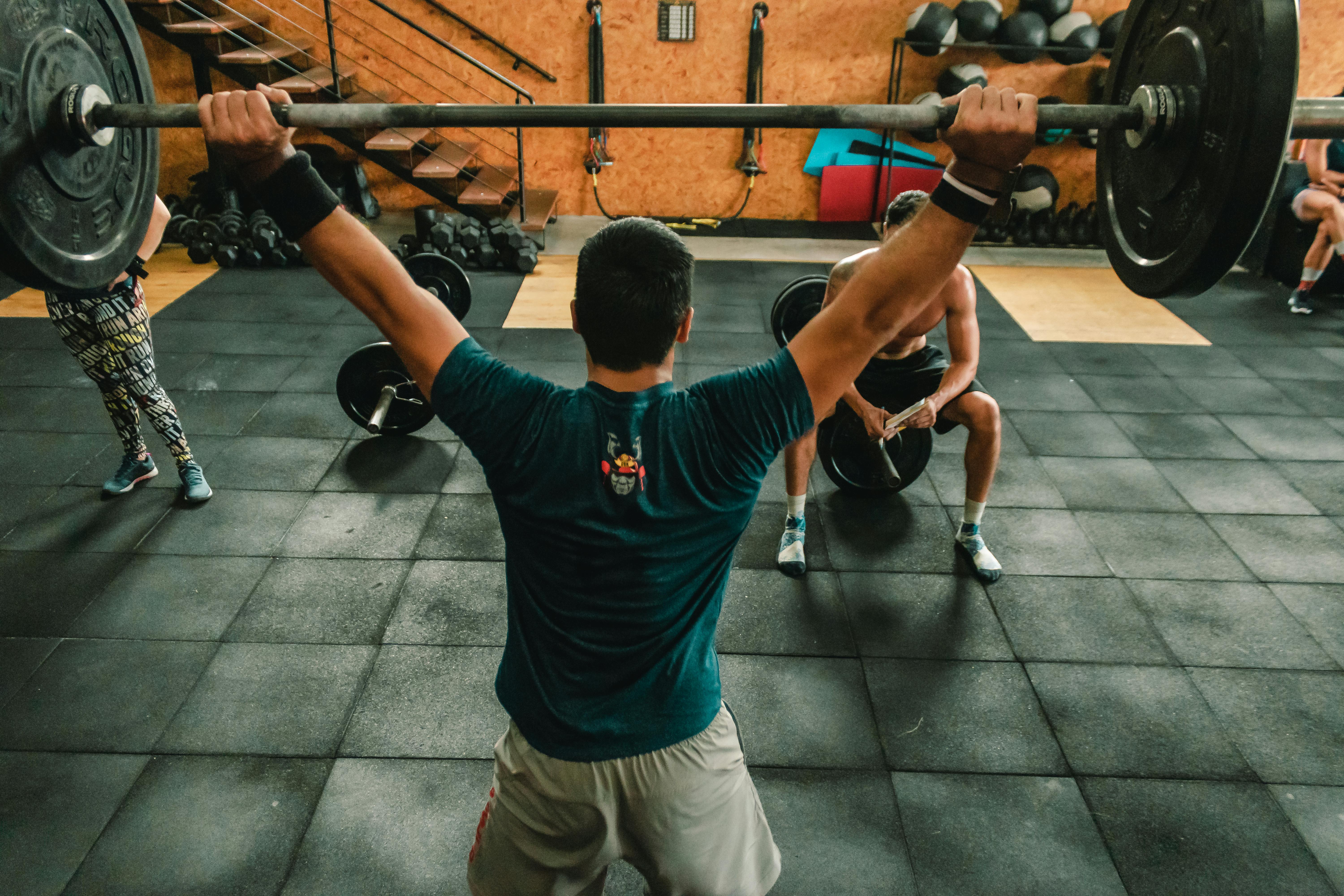 person lifting barbell indoors