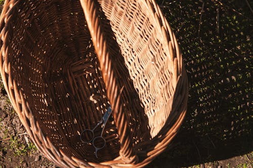 A basket with a handle and a handle on the ground