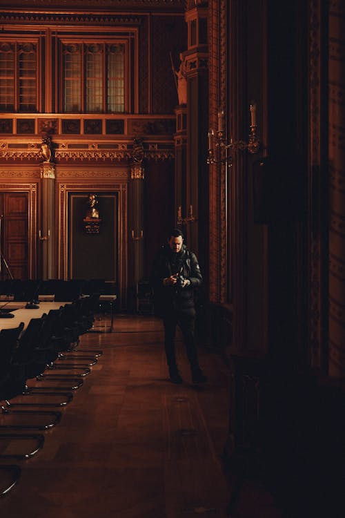 A man standing in a large room with chairs