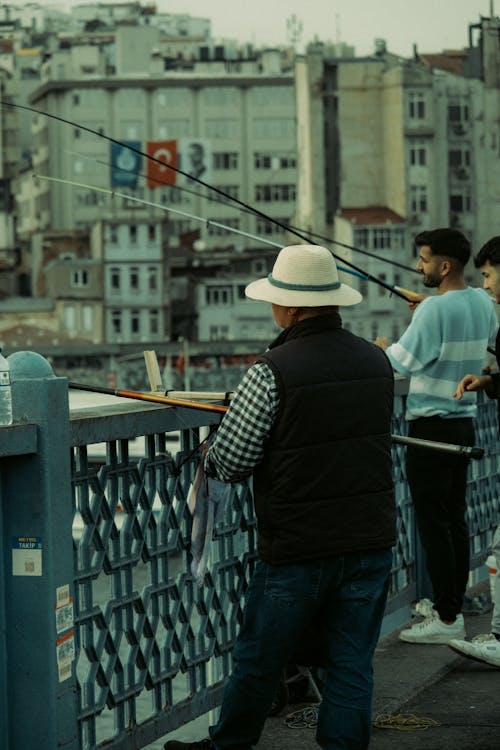 A man is fishing on a bridge