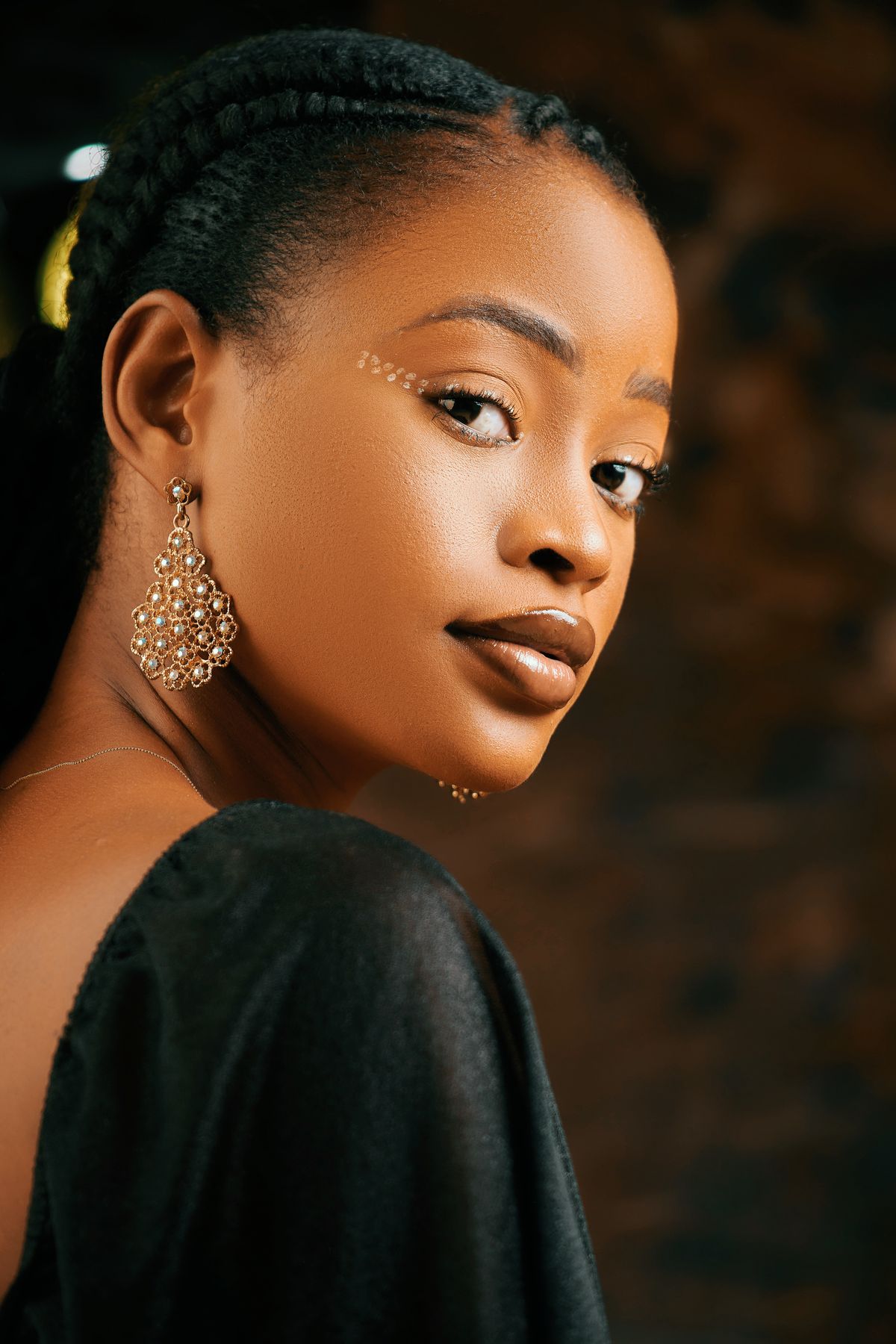 Woman with gold earrings and elegant makeup