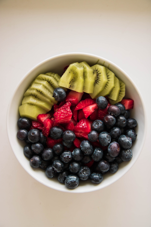 Free A delicious and colorful fruit bowl featuring blueberries, kiwi, and strawberries. Stock Photo