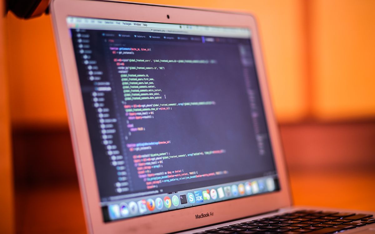 Focused shot of a laptop displaying code, suitable for tech and coding themes.