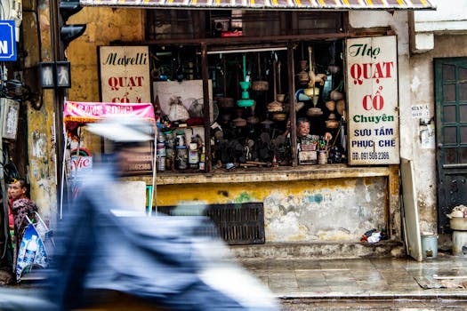 Vibrant street view in Hanoi, Vietnam capturing a local shop and bustling activity.